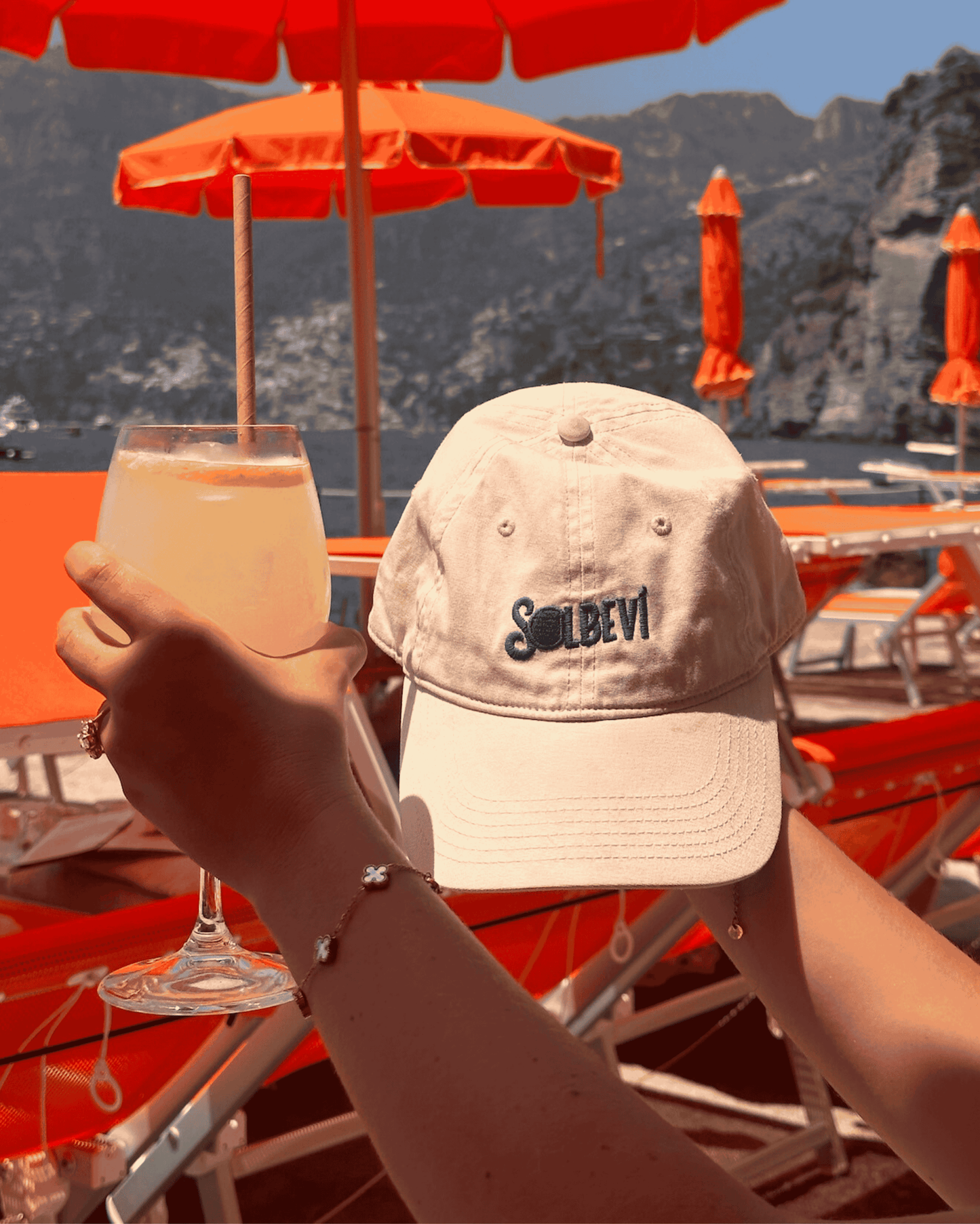 Solbevi cotton hat and Limoncello Spritz at the beach, with ocean view in background